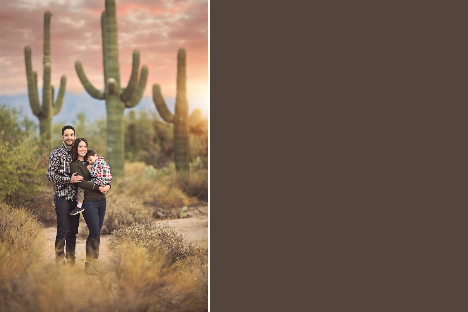A family of three with their three-year old son cuddle amongst towering saguaros during a fall sunset at Sabino Canyon