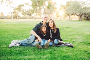 A young family enjoy the warm fall evening amongst the grass and trees during the family photo session at Tucson Country Club