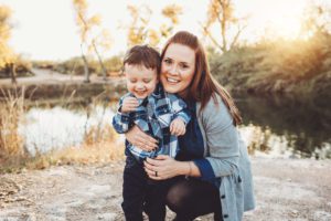 A young mom hugs her giggling son near the Tanque Verde Guest Ranch lake