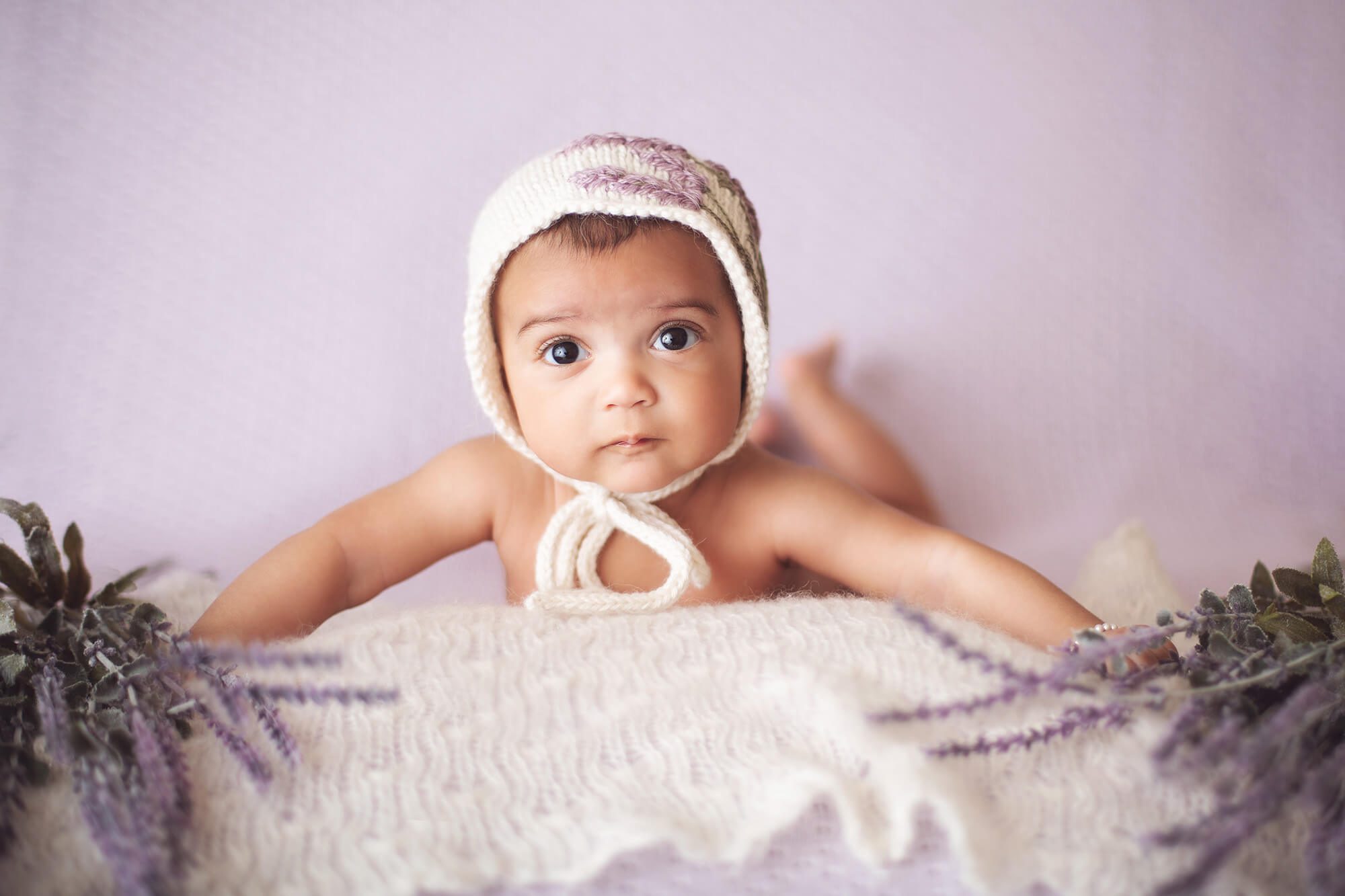 Baby Evelyn during her 3-month milestone session surrounded by lavender