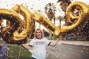 University of Arizona senior, Shelby, celebrates her graduation with balloons and confetti during her senior portrait session on the U of A campus