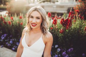 University of Arizona senior, Shelby, giggles during her senior portrait session in front of the fountain at the Old Main building on the U of A campus