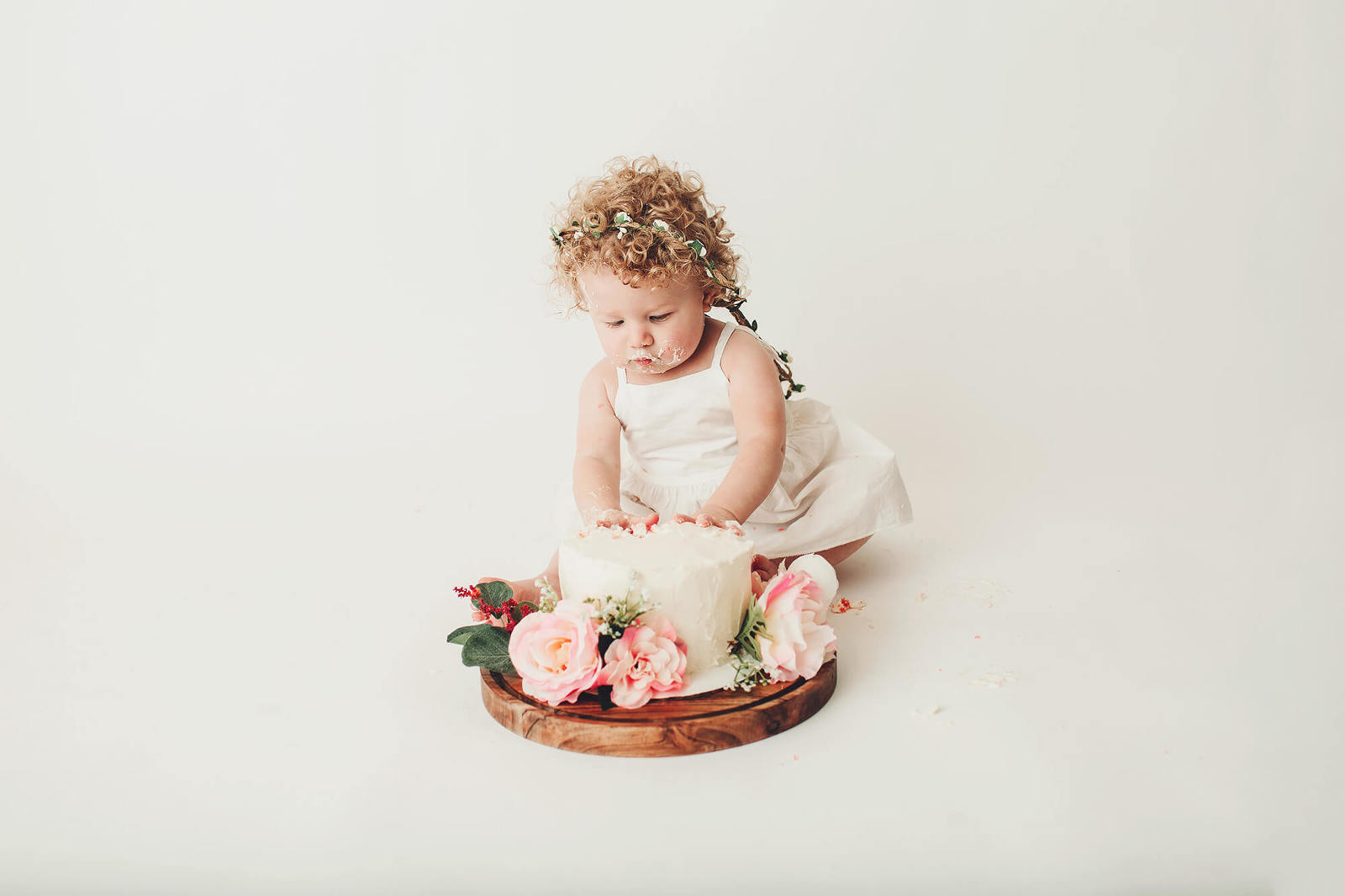 Cake smash session with pink flowers and a petite floral crown