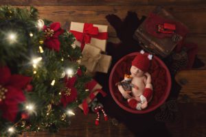 Newborn baby under a Christmas tree by Tucson newborn photographer Belle Vie Photography