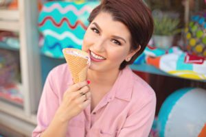 A local Tucson food blogger poses with an ice cream cone during her photo session at the Hub Ice Cream Factory.