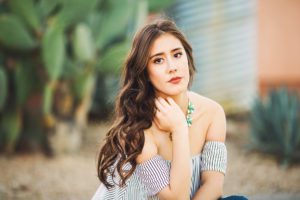 Class of 2019 senior, Brianna, is gorgeous in stripes as she poses in a quaint, Tucson neighborhood