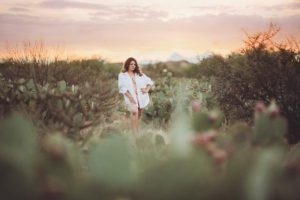 A young woman in a white shirt during her sunset boudoir session