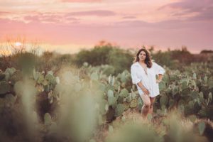 A young woman in a white shirt during her desert boudoir session
