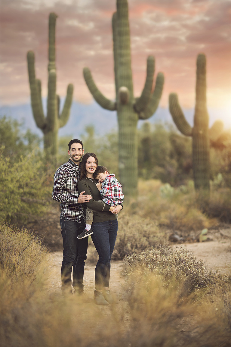 Tucson family standing amidst the majestic saguaros of Sabino Canyon during a family holiday photo session in Tucson