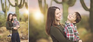 Mother and son giggles and cuddles during a family holiday photos session in the Tucson desert with a saguaro and sunset backdrop