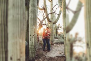 The Freeman's snuggle together in the light of the setting sun surrounded by saguaros during their sunset photo session in Tucson