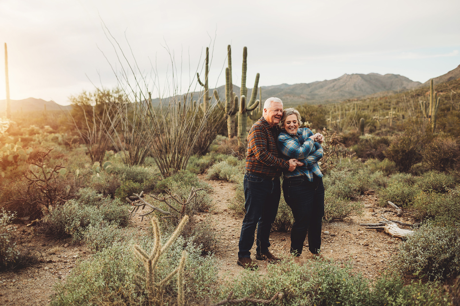 A couple dance together at sunset amongst the saguaros at Gates Pass in Tucson during their 2018 family session