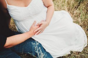 Parents-to-be cradle the baby bump during their maternity session