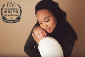 A mom holds her baby son during her newborn session with Belle Vie Photography in Wiesbaden