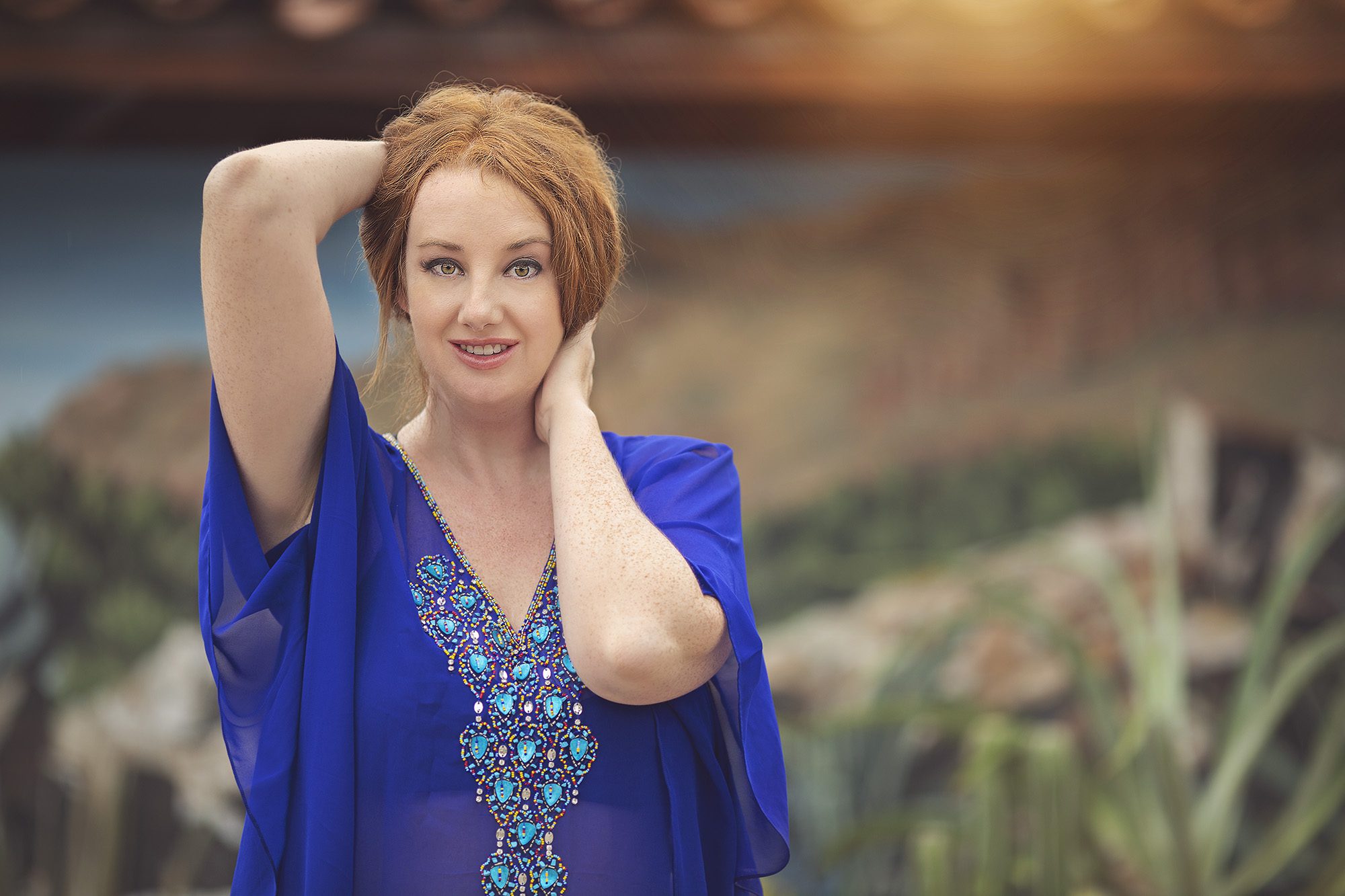 Phoenix blogger, Mandy, poses in front of a desert mural near the resort's pool.