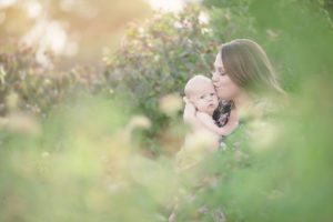 A mom kisses her baby son during her breastfeeding session at Reid Park's rose garden in Tucson