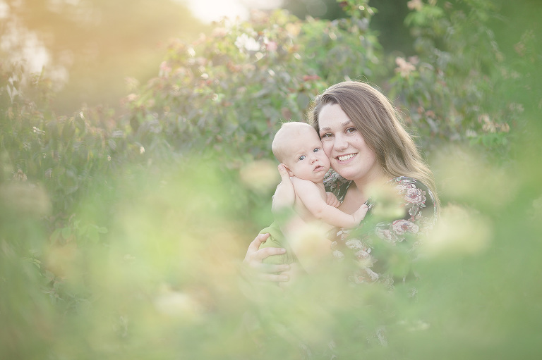 A breastfeeding mom cuddles her baby son at sunset during her breastfeeding session at Reid Park's rose garden in Tucson