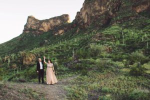 A couple dances amidst mountain peaks during their engagement session at Picacho Peak with Belle Vie Photography