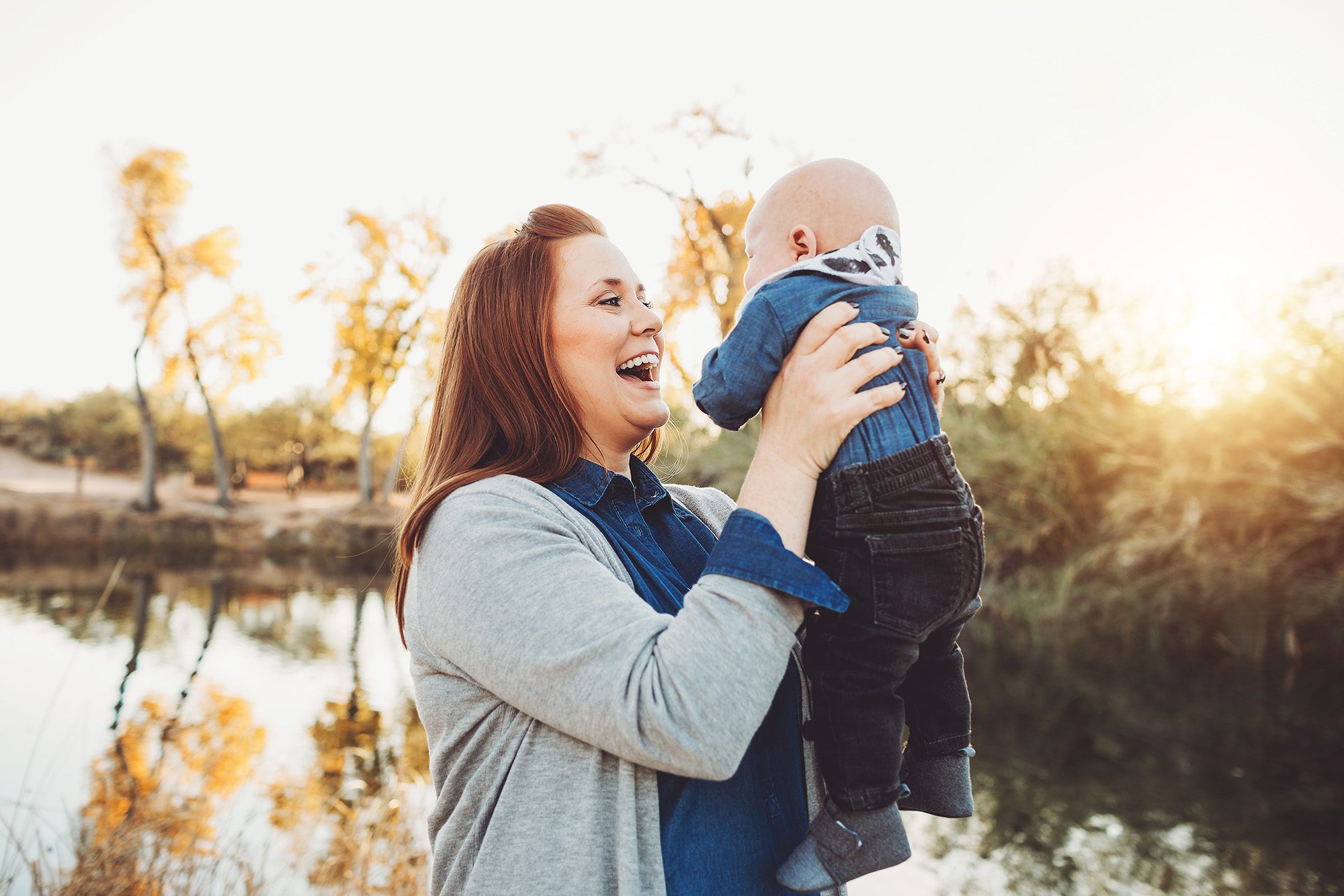 Mom Schlosser happily holds baby during a family photo session at Tanque Verde Guest Ranch