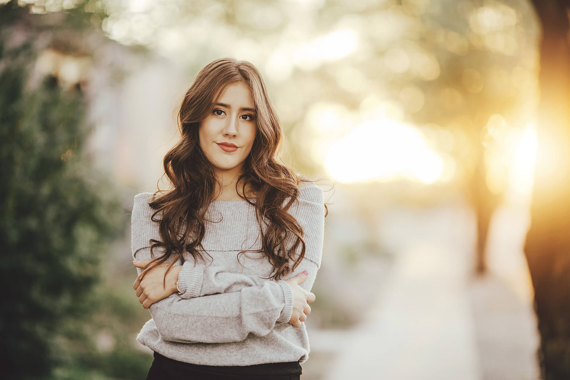 Brianna, a Tucson senior, glows brighter than the setting sun as she poses during her senior photoshoot in a gorgeous southeast Tucson neighborhood