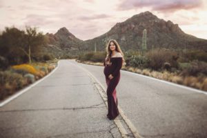 The pink hue of sunrise was a gorgeous complement to the desert tones and Anica's maternity gown during her maternity session with Belle Vie Photography in Tucson