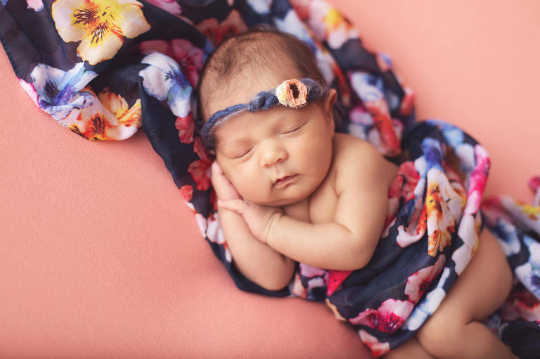Baby Valentina during her newborn session with Tucson newborn photographer wrapped in a floral scarf