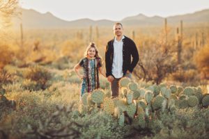 Father and daughter stand together at sunset during their desert family photo session in the desert near Tucson with Belle Vie Photography