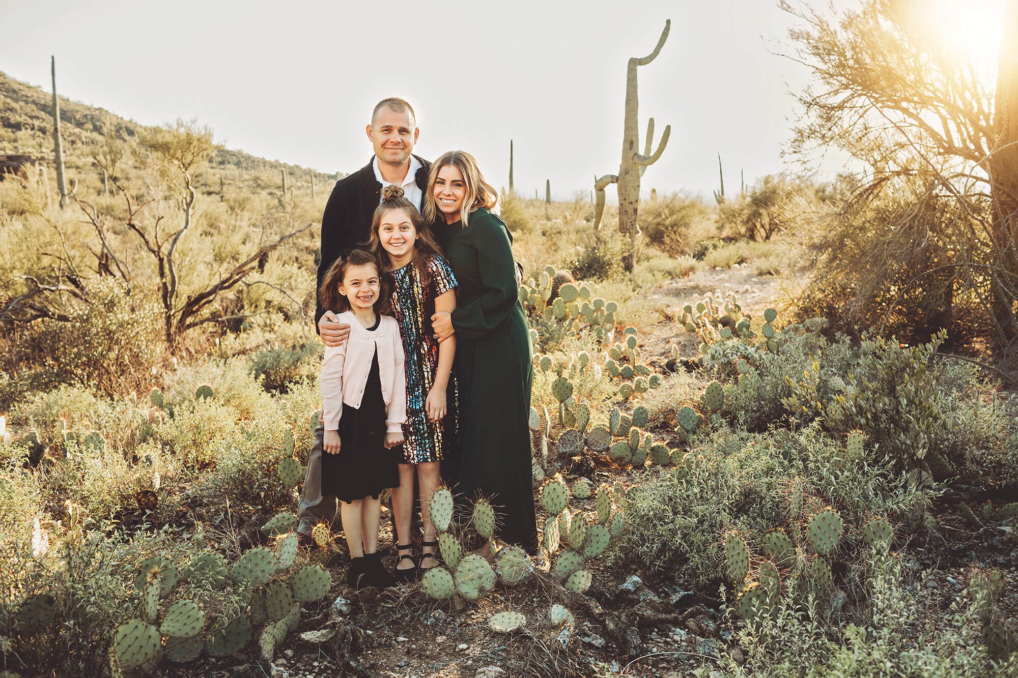 The Gunter family cuddling together in the cool winter Tucson air during their desert family photo session