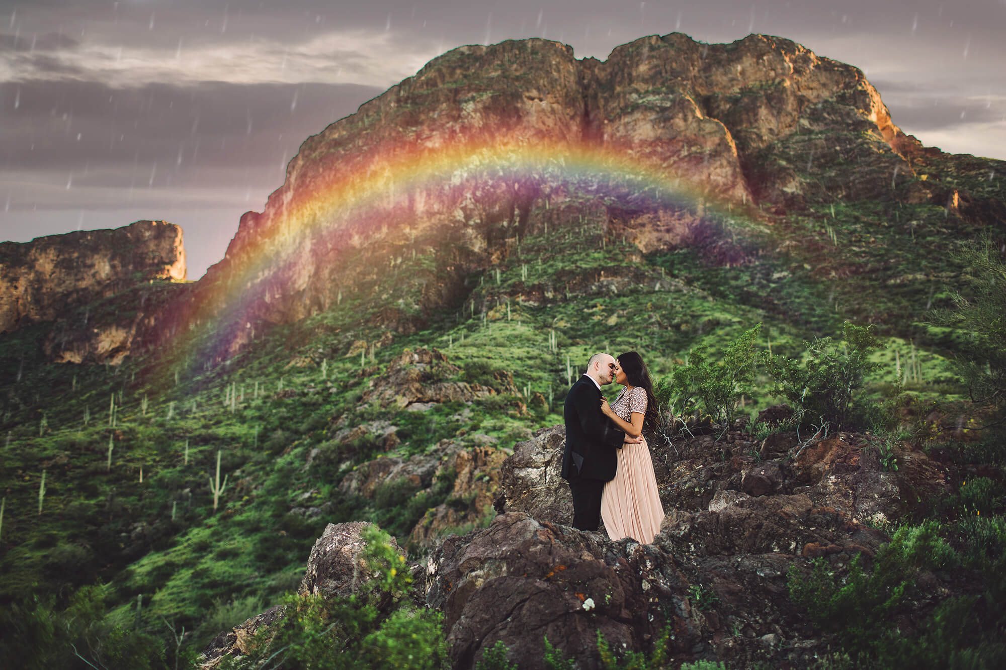 The Paxman's together under a rainbow at the base of Picacho Peak during their couple's session