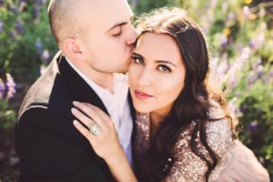 Brand kisses Vaness during their spring couple's wildflower session at Picacho Peak