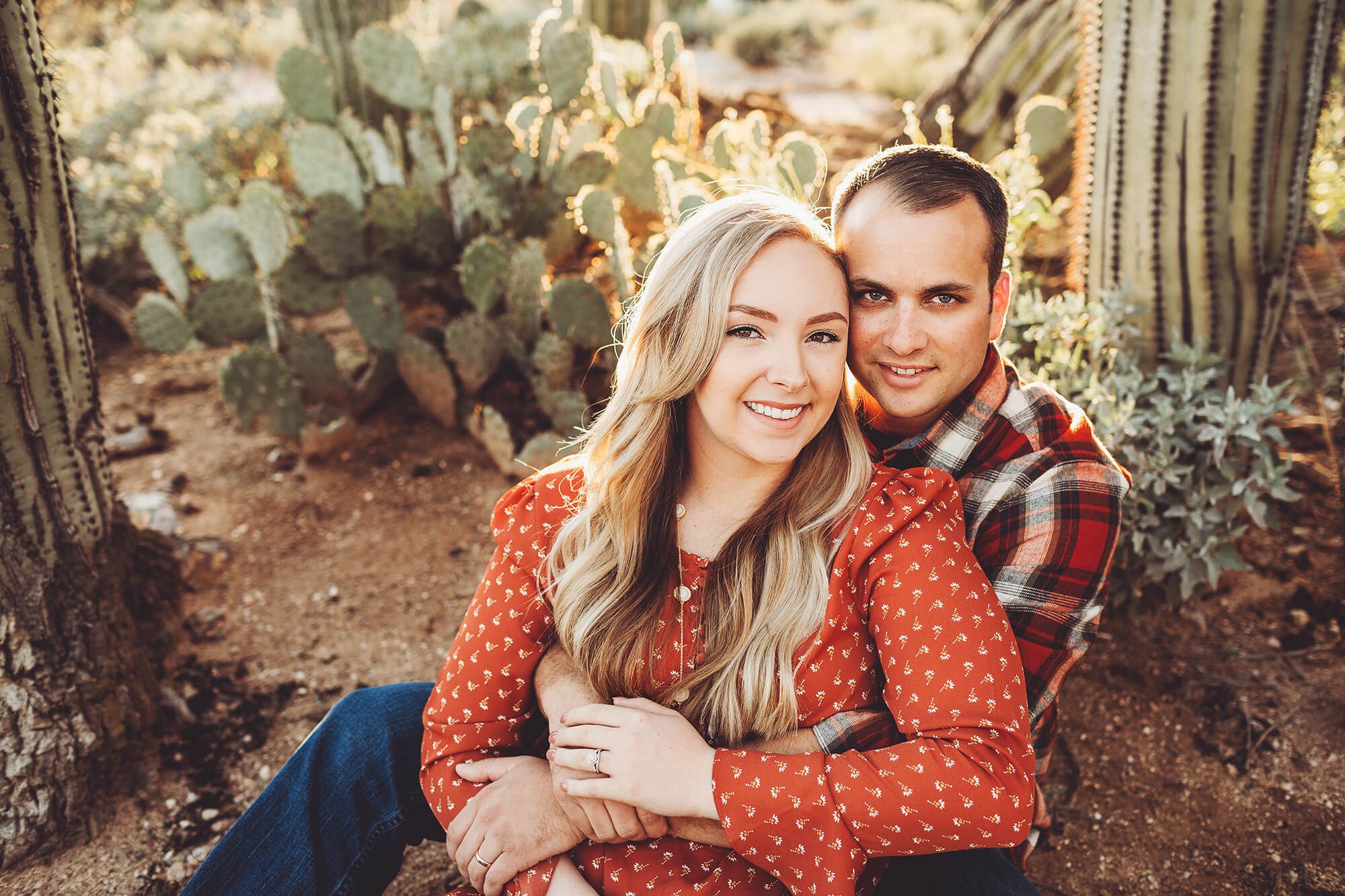 Enjoying the sunny Tucson evening and holding each other closely, the Freeman's happily smile during their sunset couple's session at Sabino Canyon