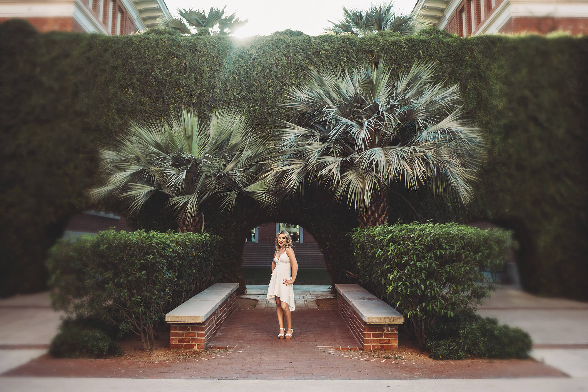 Shelby in starts her senior portrait session standing in front of gorgeous campus architecture at the University of Arizona