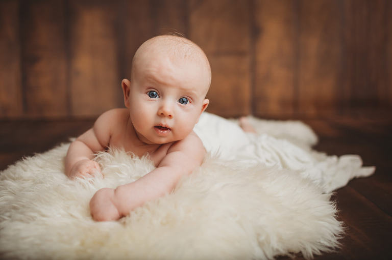 Three-month milestone session by Belle Vie Photography in Tucson of a baby boy on his tummy on a fur rug