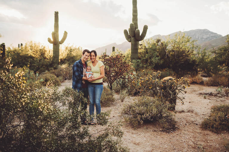 A new mom and dad cradle their baby son during a spring family session at Sabino Canyon