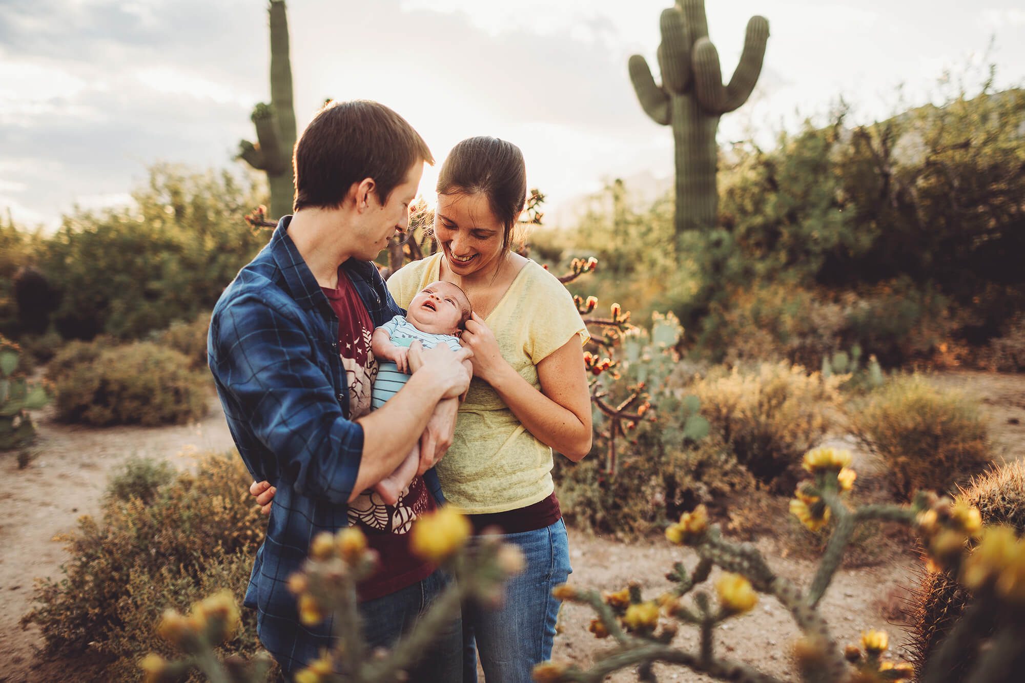 The Sgoutas family cuddles together in the spring sunlight during their family session in Tucson with Belle Vie Photography