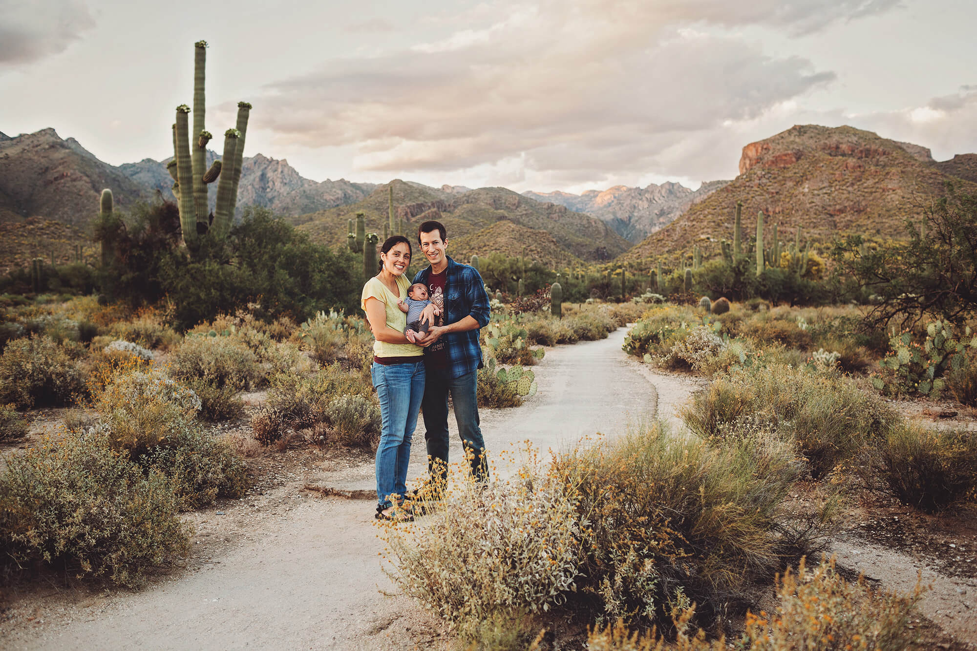 The Sgoutas family cuddles their newborn baby boy to keep him warm amidst the cool temps and wind at Sabino Canyon.