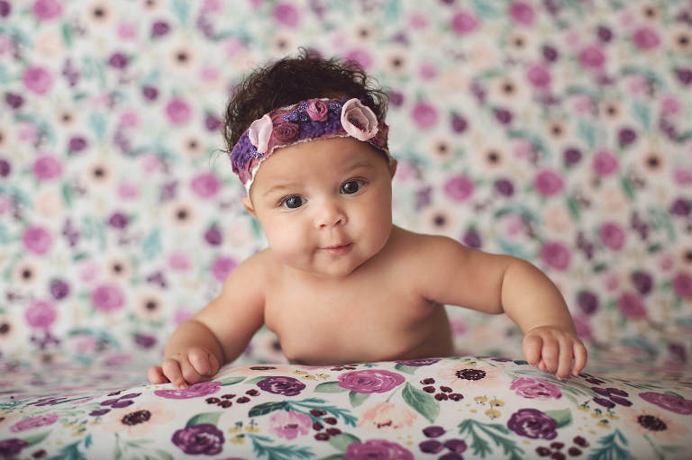 A beautiful baby in purple during her three-month milestone session.