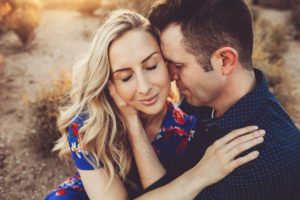 A loving embrace surrounded by golden Tucson sunlight during an engagement session
