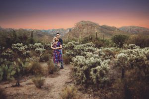 A couple stands amidst the jumping cactus at Sabino Canyon