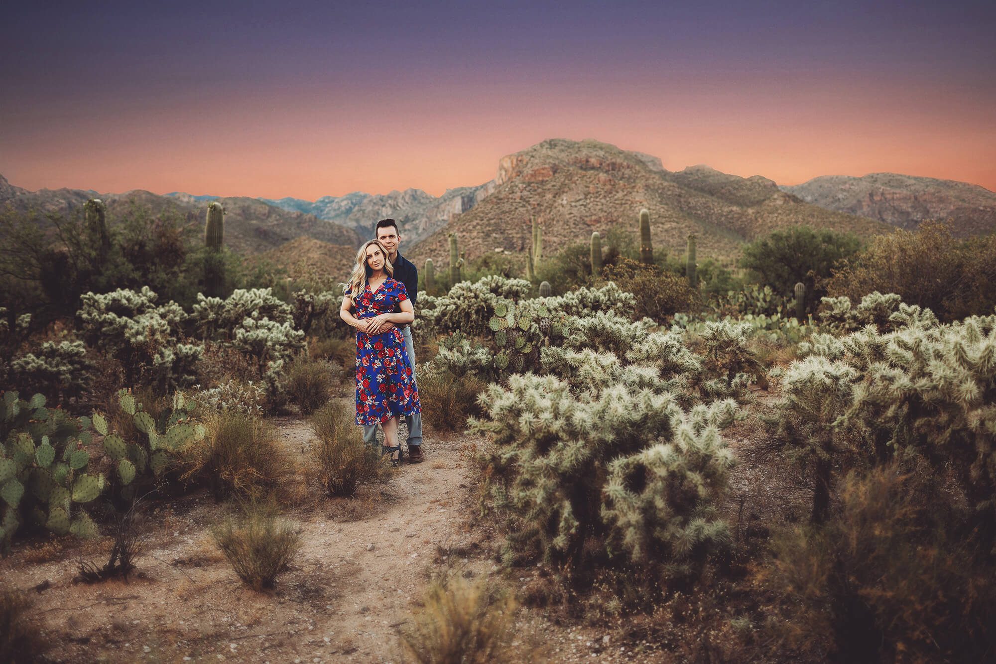 A couple stands amidst the jumping cactus at Sabino Canyon