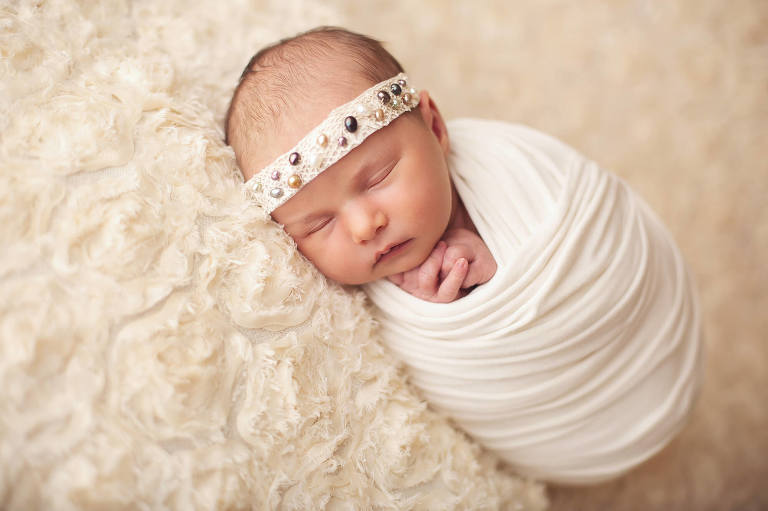 A sleeping beauty during her newborn session. The wrap helped her calm and stay asleep during her session.