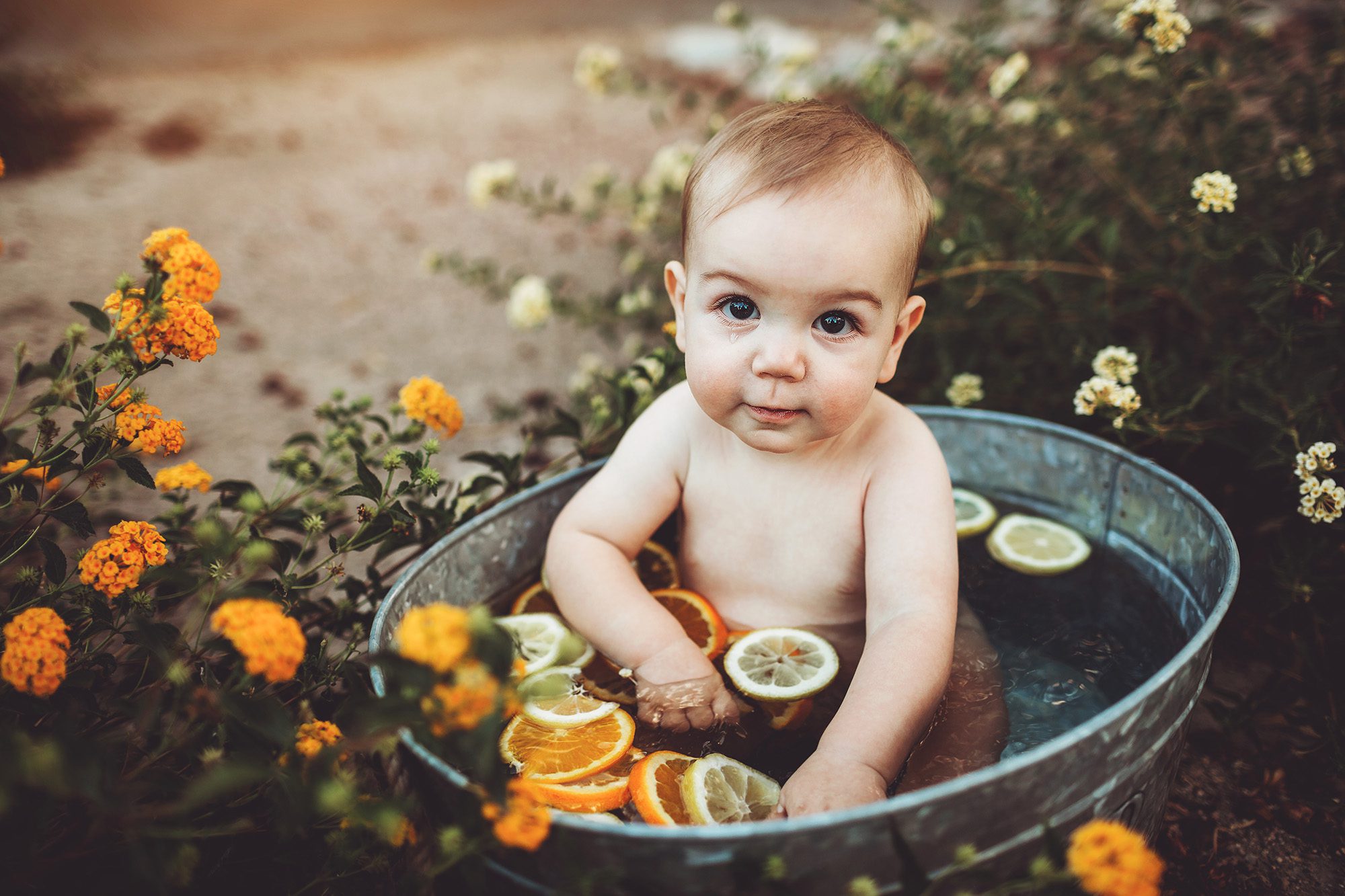 Baby Felix sitting in a cool fruit bath filled with fruit