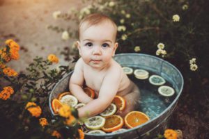 Baby Felix stares at the camera during his fruit bath session