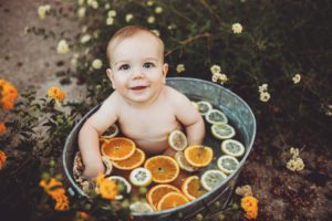 An adorable baby smile during a hot summer fruit bath session