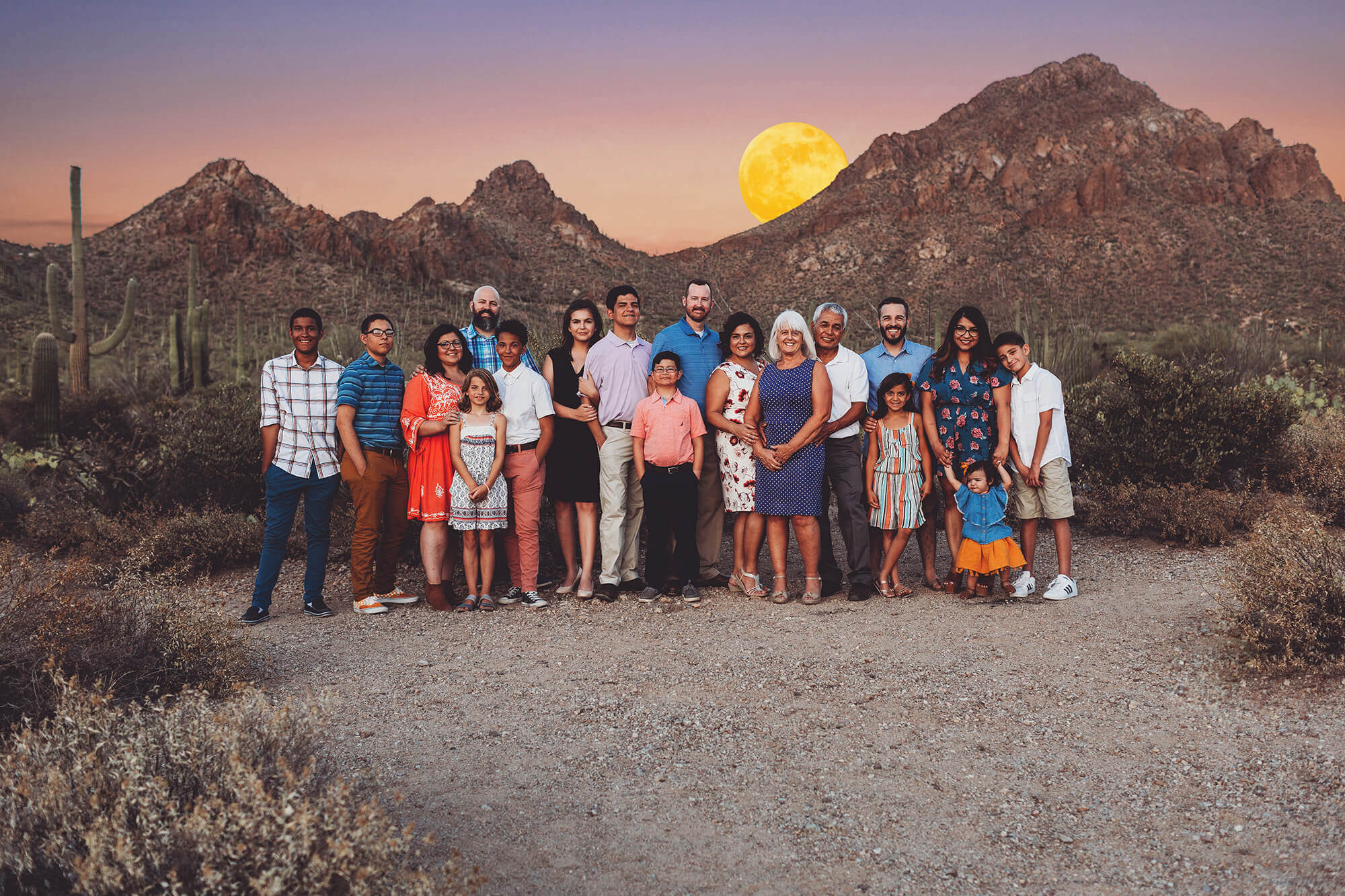 The Castillo family all together with Gates Pass in the background and June's rising Strawberry Moon.
