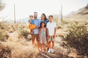 A family of 5 at Gates Pass in Tucson during their family photo session in the hot June sun