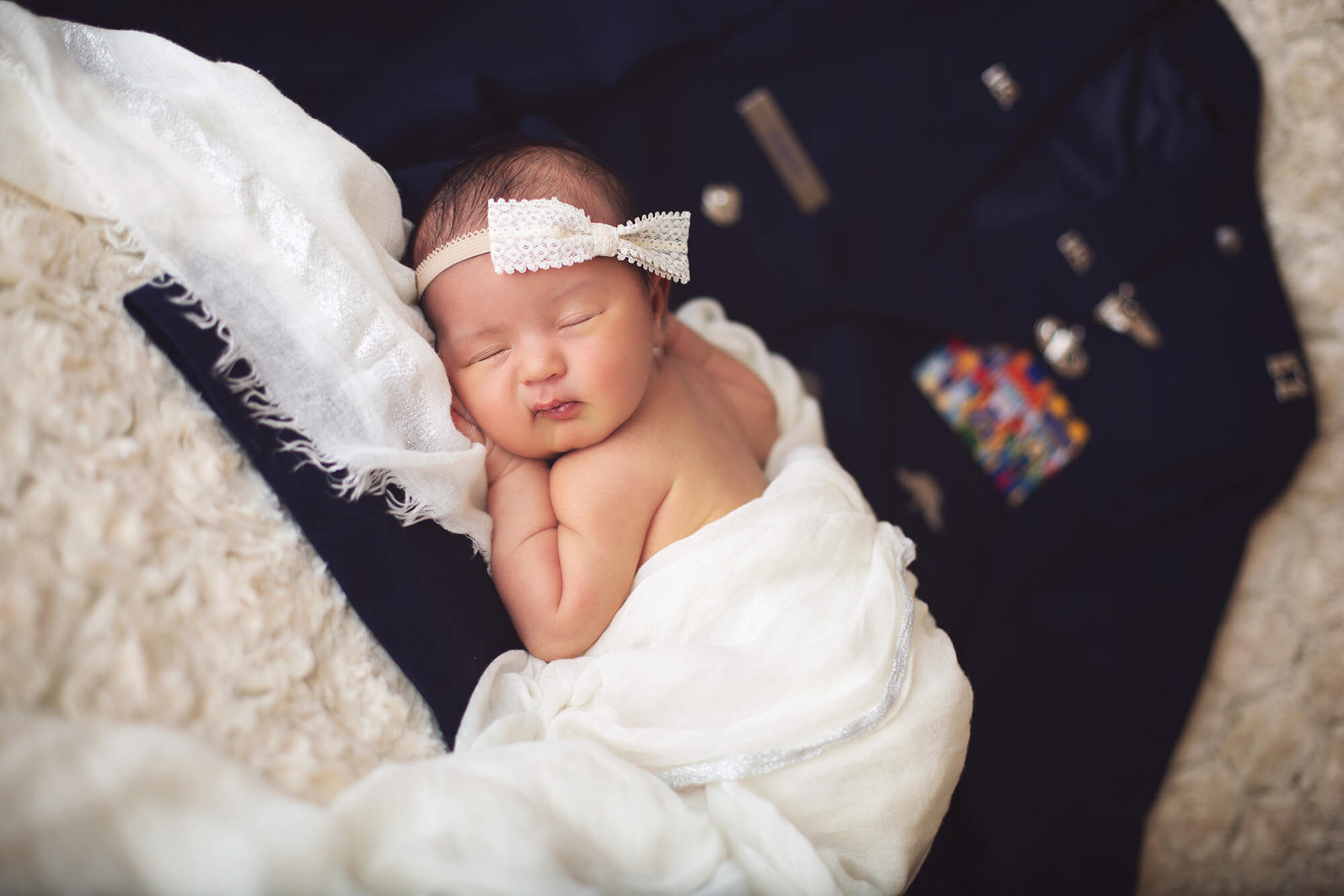 The daughter of military laying on her dad's Air Force dress jacket.