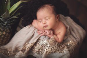 Baby girl with her pineapple during her newborn session