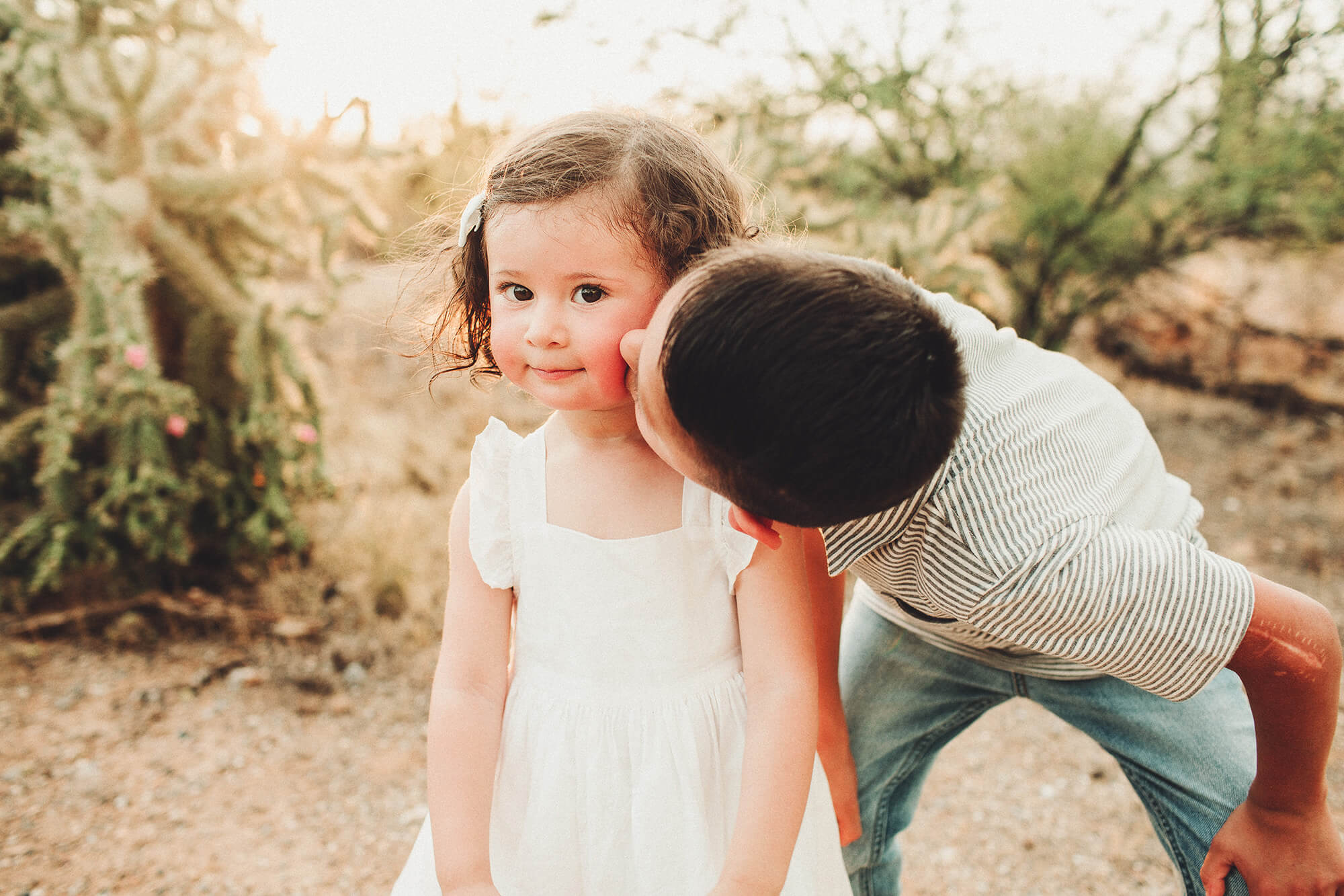 The sweetest big brother giving his darling little sister a kiss on the cheek