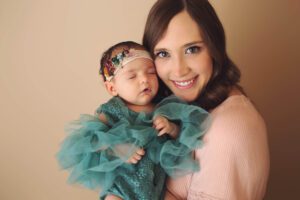 Amelia and her mom while her mom smiles at the camera